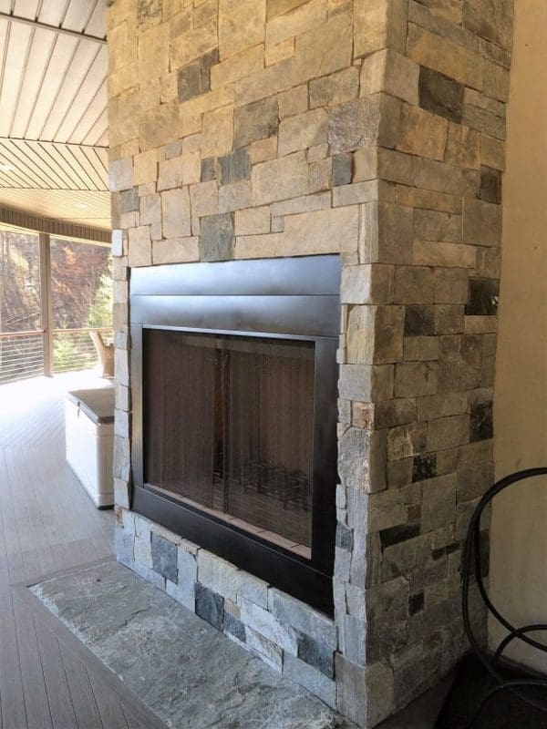 Drystack outdoor fireplace with natural stone veneer