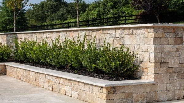 A planter with cream colored natural stone veneer.