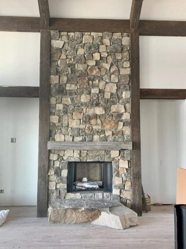 Moss Rock thin stone veneer installed on a fireplace