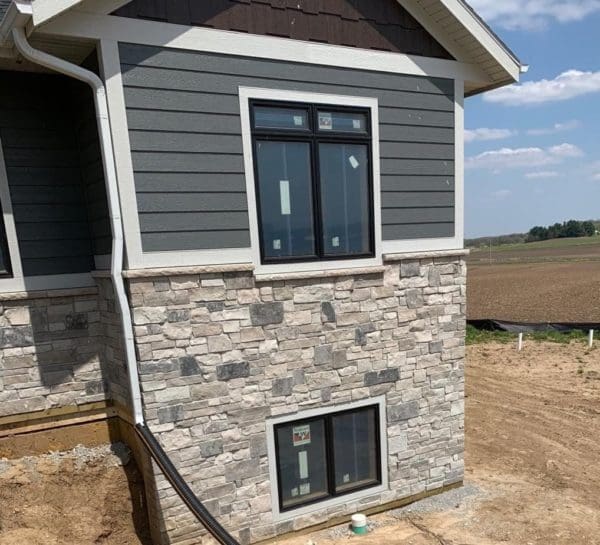 Exterior siding with Graphite natural stone veneer