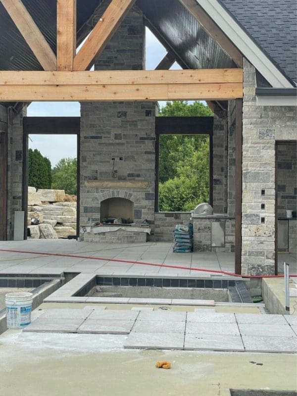 Covered patio and fireplace with Graphite black and gray ashlar style natural stone veneer