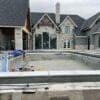 Backyard pool installation with Graphite real stone veneer