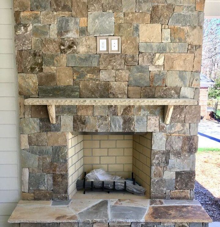 Outdoor fireplace with Rochester and Whistler natural stone veneer
