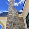 Exterior accent wall and chimney with Rochester and Whistler natural stone veneer