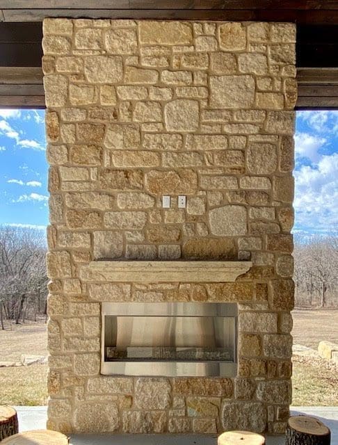 Covered patio and outdoor gas fireplace with Winfield natural thin stone veneer