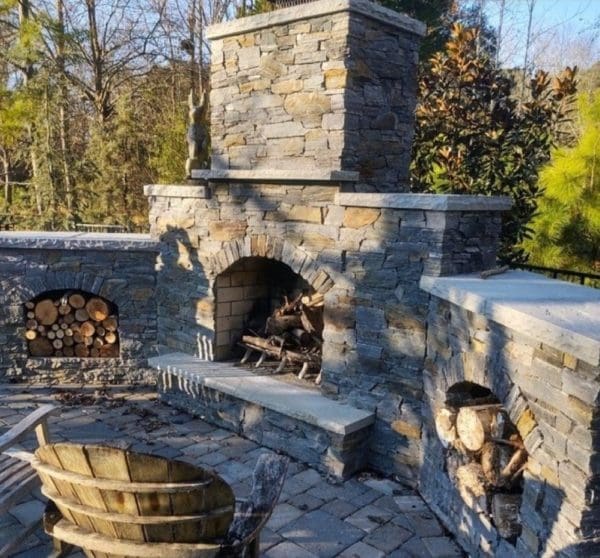 Outdoor living wood burning fireplace with drystack Brighton real stone veneer