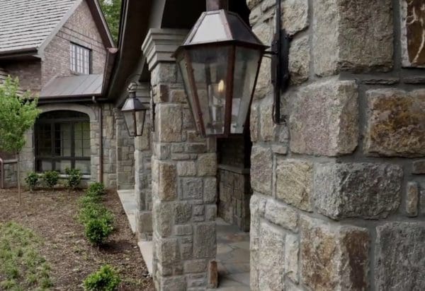 Home exterior and outdoor living area with Reedley castle rock style real stone veneer