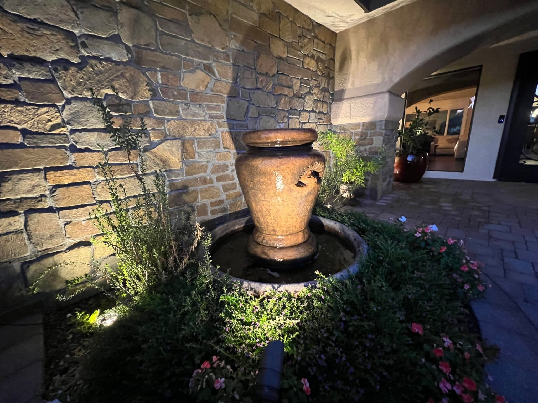 Cabernet Natural Stone Veneer Exterior with Fountain at Twilight