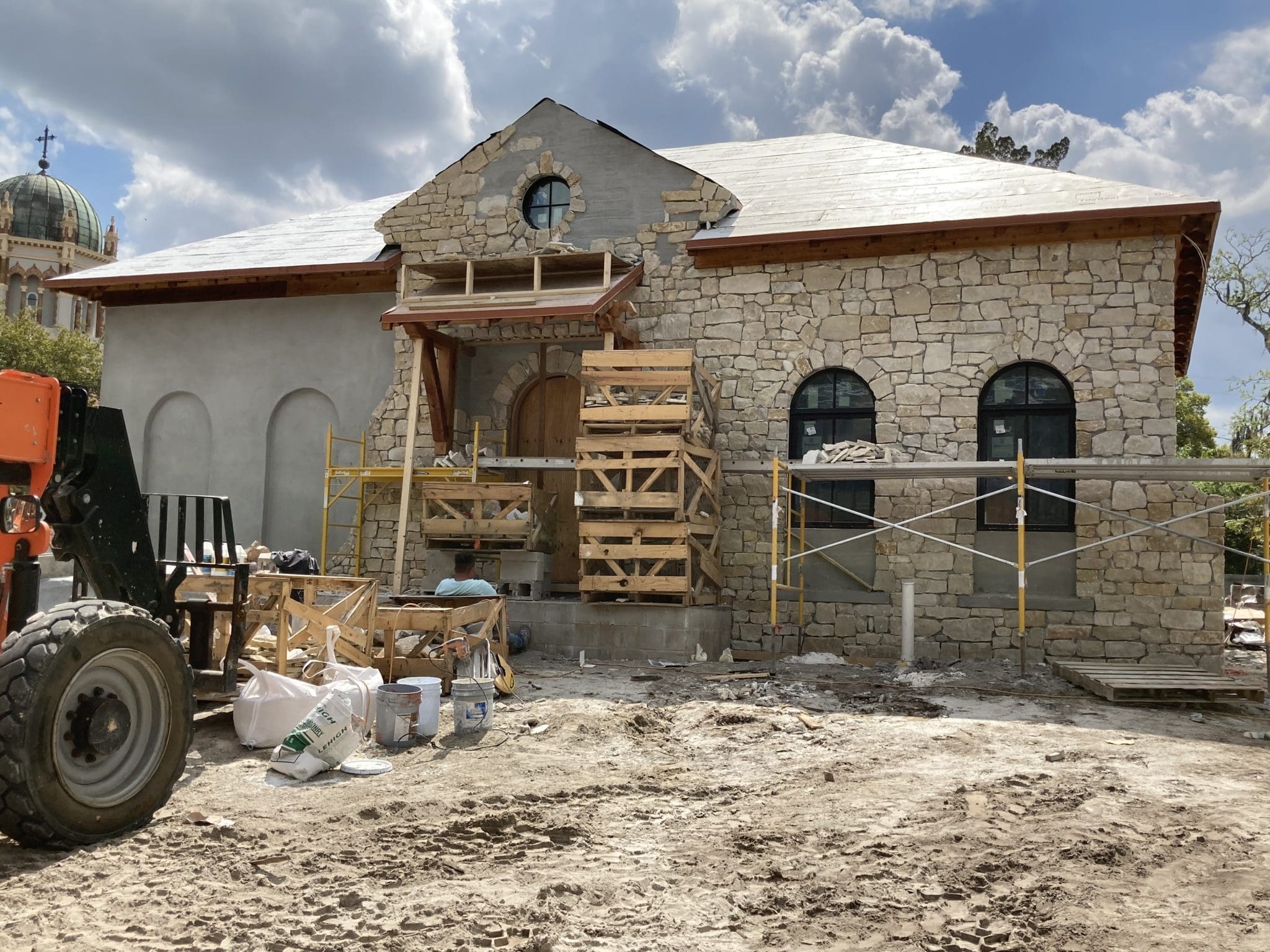 Natural limestone veneer being installed on a home exterior.