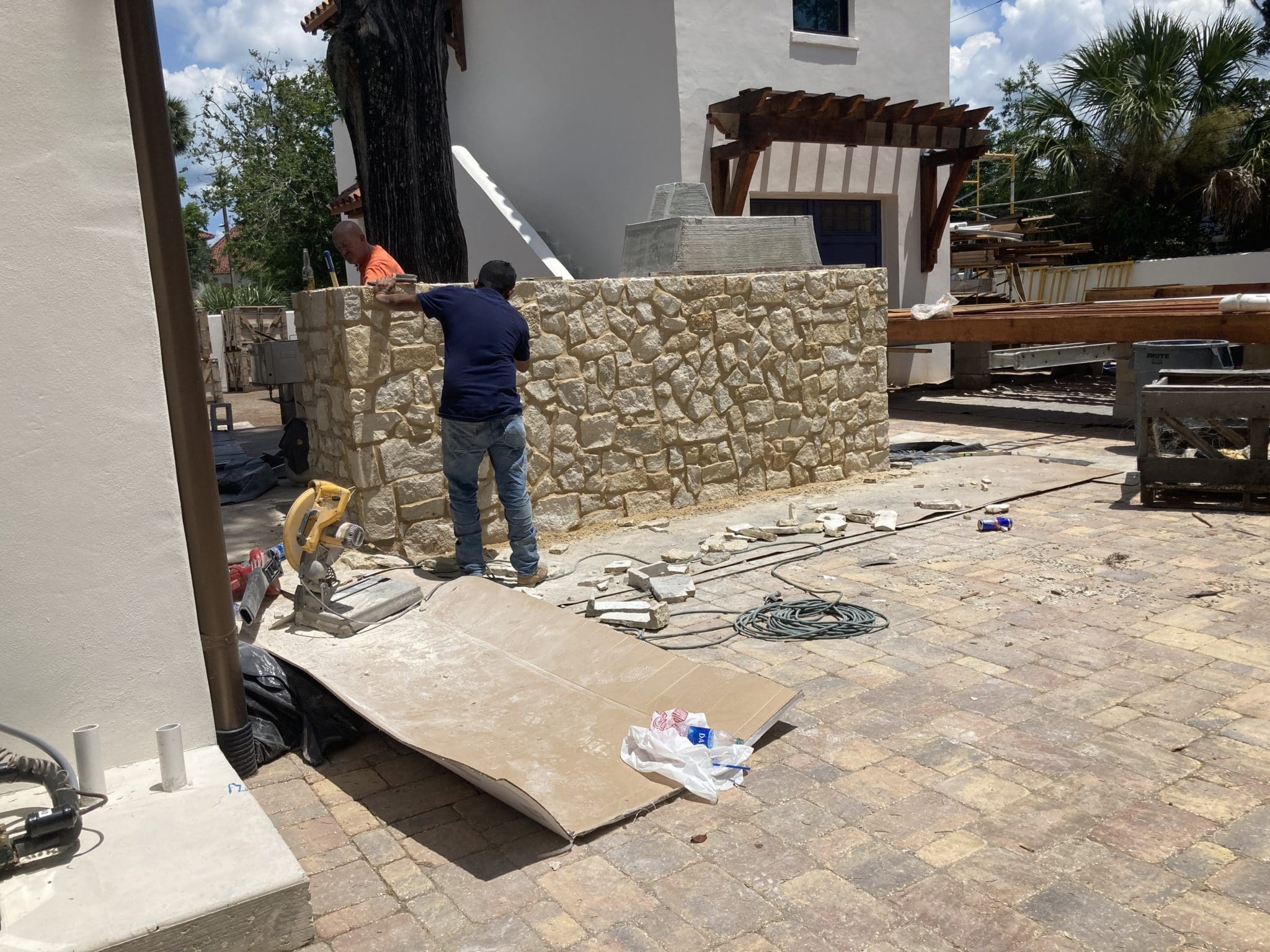 Outdoor grill with natural stone veneer being applied.